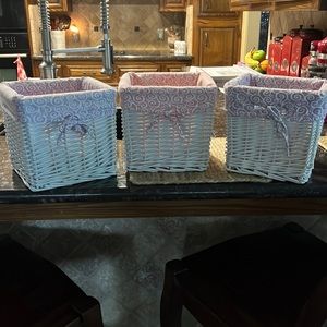 Three white baskets with liners